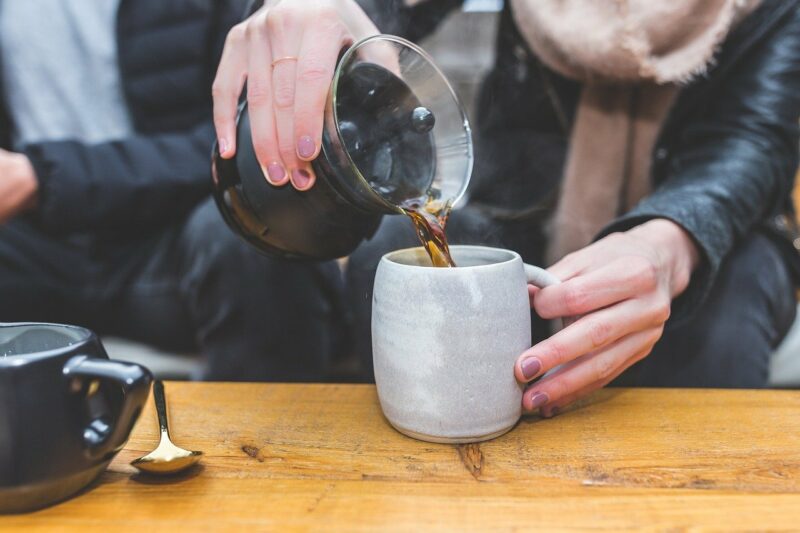 Pouring coffee into coffee cup